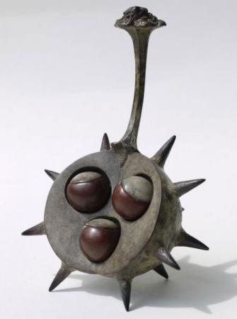 Three conkers in shell, bronze.